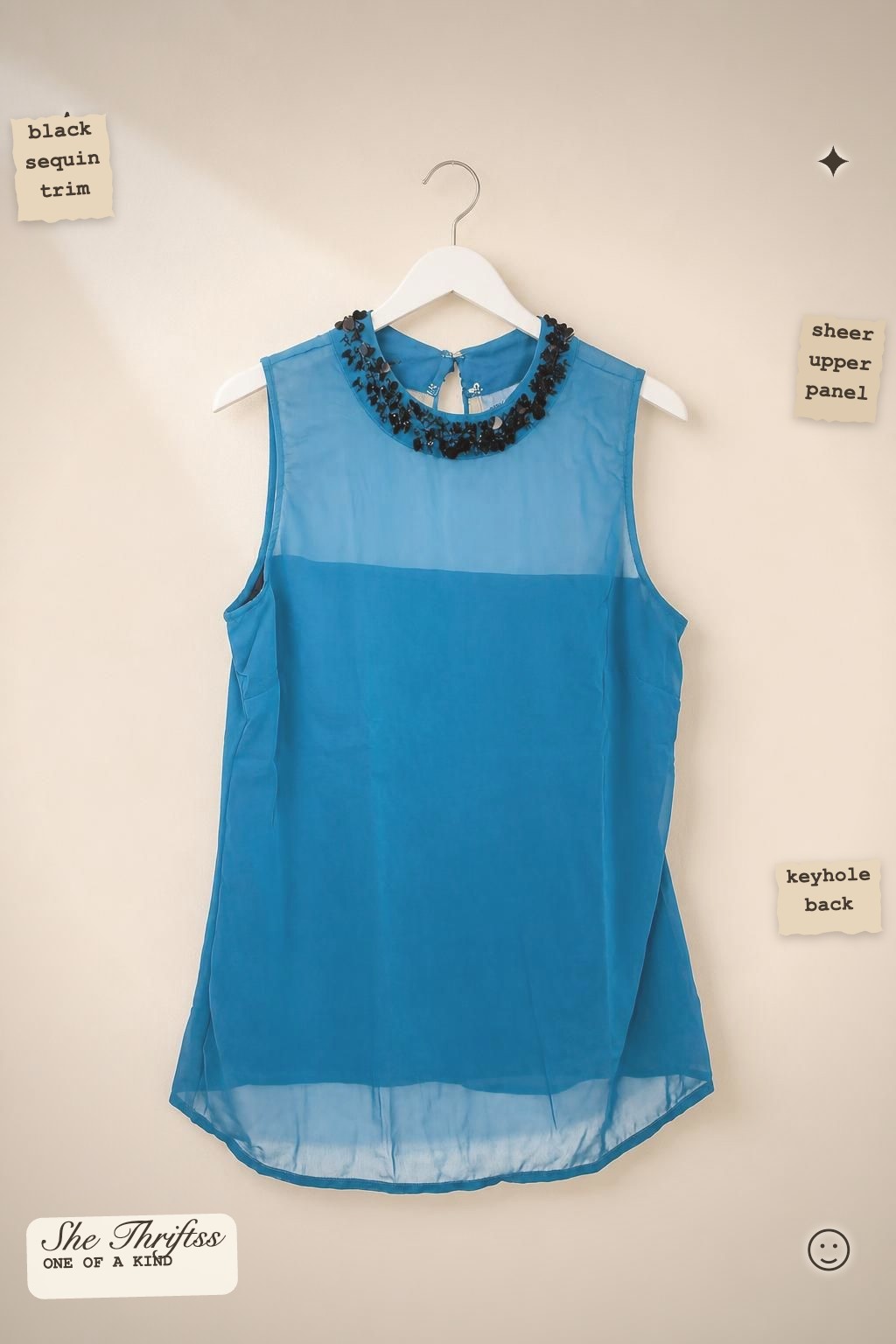 Blue embellished sleeveless blouse